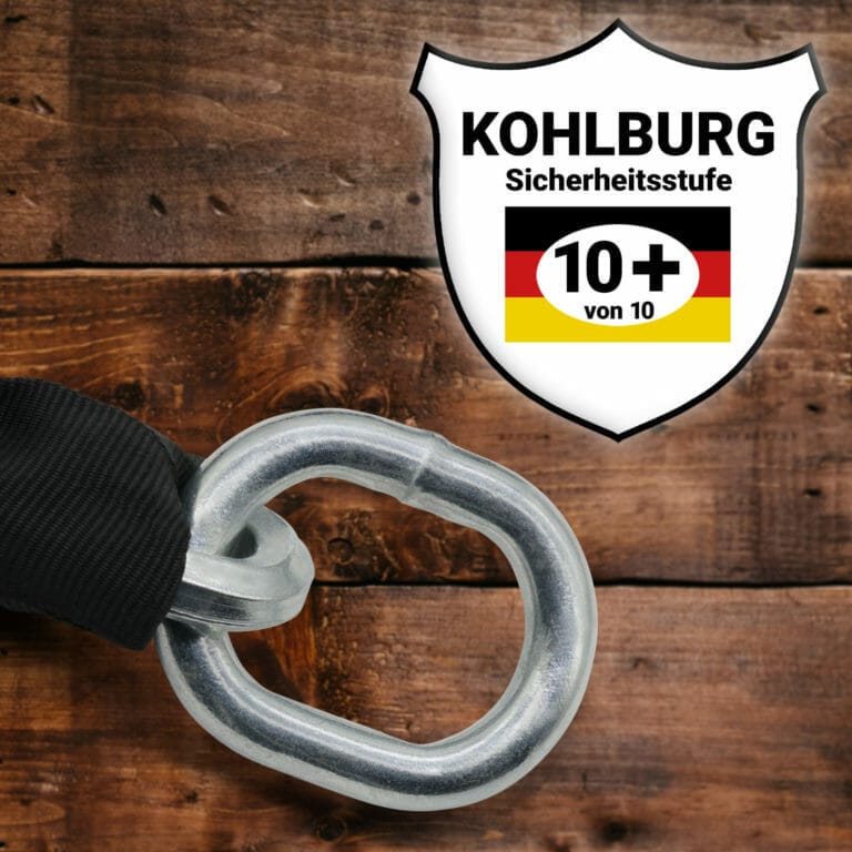 Ein Metall-Sicherheitskettenglied neben einem KOHLBURG-Sicherheitsausweis mit der Bewertung 10+ von 10, auf einer Holzoberfläche.